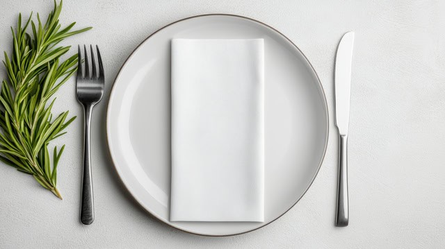 Neatly arranged white hotel linens on a luxury bed