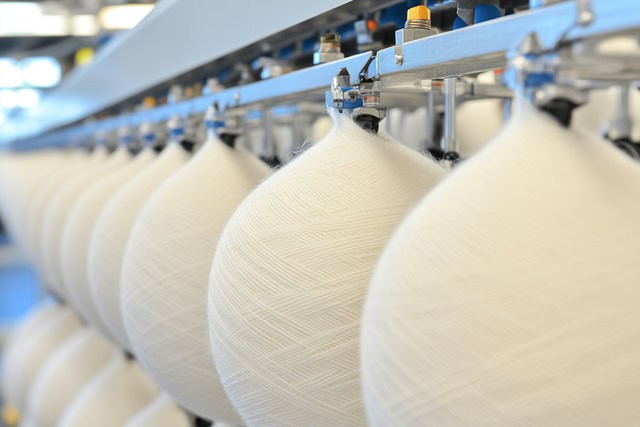 Pakistan Fibres logo with hero textile display